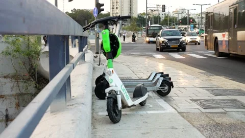 Last mile commute electric lime scooter left unattended at Ayalon Tel Aviv Stock Footage 231202604