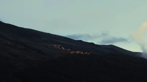 Last minutes of sunshine lighting a few trees on Mount Etna Stock Footage 88564404