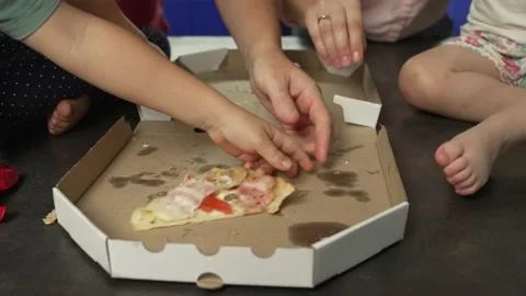The last piece of pizza in the box. Many hands grab the pizza Stock Footage 220094582