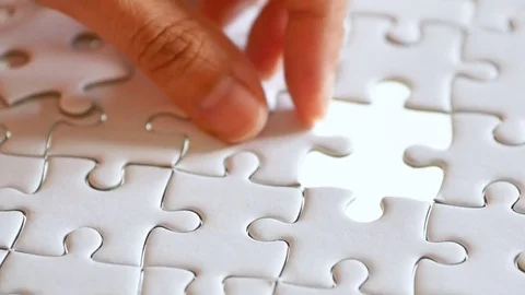 Last piece of white plain jigsaw filling by hand Stock Footage 84841645