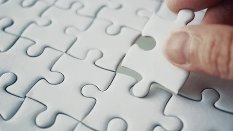 Last piece of white plain jigsaw holding by hand, step of success concept Stock Footage 108364901