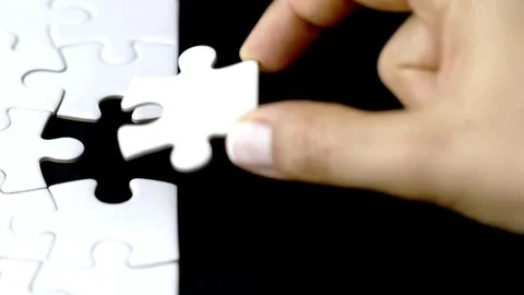 Last piece of white plain jigsaw filling by female hand, step of success concept Stock Footage 336248633