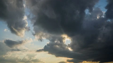 The last ray of the sun in the dark clouds of the evening sky Stock Footage 163178080