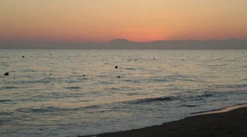 The last rays of the sun falling on the beach by the sea in autumn Stock Footage 68690366