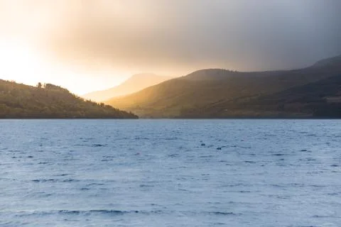Last rays of sun over Ben Lawers - view from the banks of Loch Tay Stock Photos