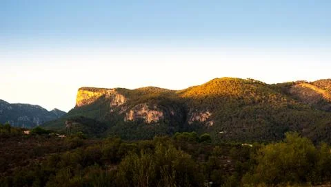 Last rays of sun over the mountain Stock Photos