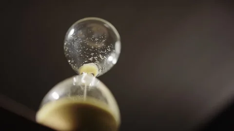 Last sand particles falling through bottleneck of hourglass, deadline concept Stock Footage 297358331