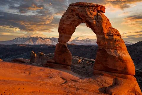 Last Sunset Light on Delicate Arch and the Mountains, Arches National Park, Utah Stock Photos