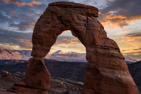 Last Sunset Light on Delicate Arch and the Mountains, Arches National Park, Utah Stock Photos