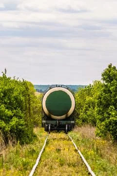 Last wagon cistern of freight train on a single track railroad Stock Photos
