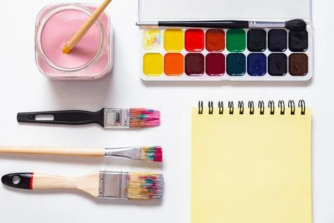Lat Lay of Creative Art Tools with Yellow Notepad and Paint Stock Photos