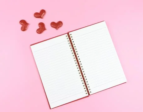Lat lay of opened red notebook or diary with red glitter hearts on pink bac.. Stock Photos