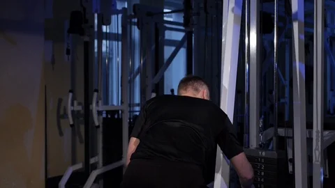 Lat pulldown.A young man does a back muscle exercise on a simulator.copy space Stock Footage 115249841