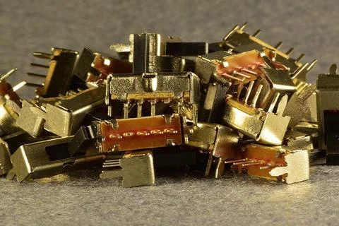 Latching mechanical 3-position microswitches lying in a mess on the desktop Stock Photos