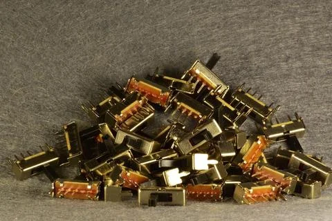 Latching mechanical 3-position microswitches lying in a mess on the desktop Stock Photos