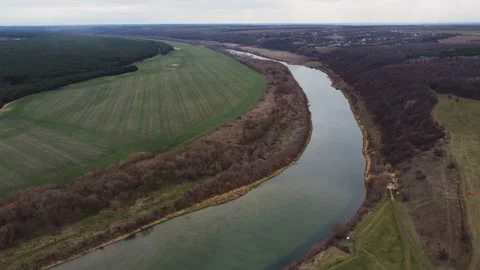Late autumn, empty trees, field. The big river flows through the banks Stock Footage 167622945