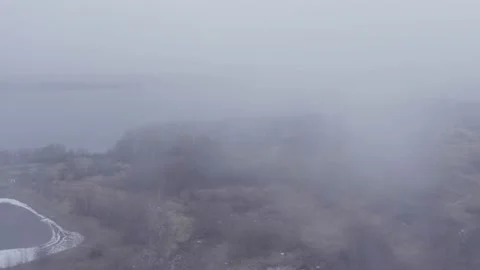 Late autumn, empty trees, heavy fog, enveloping everything around the river Stock Footage 167622840