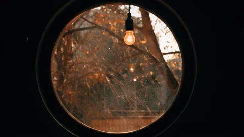 Late autumn light bulb round window Stock Footage 226971199