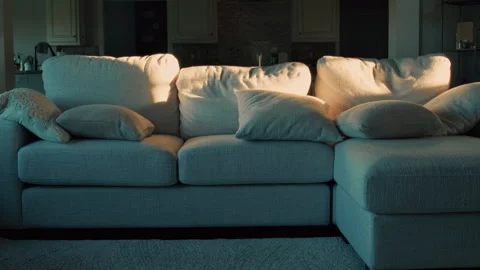 Late Day Sunlight Casting Patterns Across Cozy Beige Sectional Sofa Stock Footage 345537367