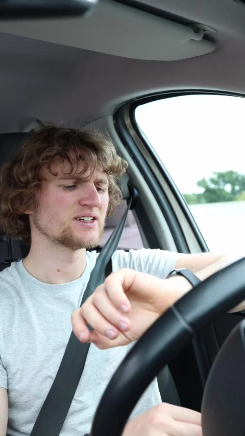 Late driver checks his watch and worries during a heavy city traffic delay Stock Footage 342922364
