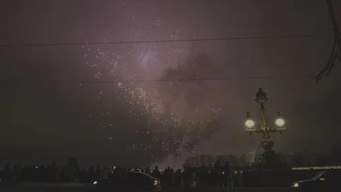 Late evening people silhouettes watching fireworks from the bridge Stock Footage