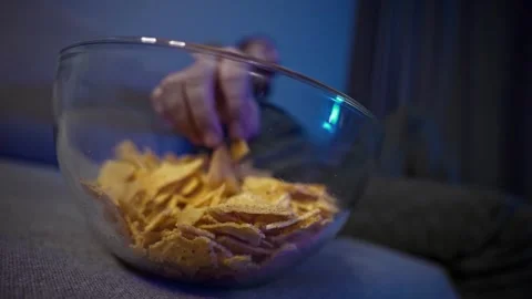 Late-night couch routine with TV and snacks. Casual evening routine. Stock Footage 323462025
