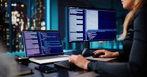 Late Night Engineer Working On Software Code At Office Desk. Stock Photos