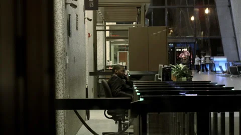 Late Night Office Security Guard Sits Stock Footage 138125499