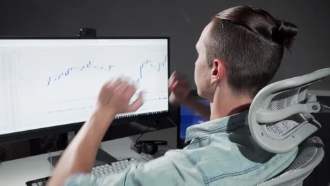 Late-night programmer stretching in his chair while analyzing data Stock-Footage 311915408
