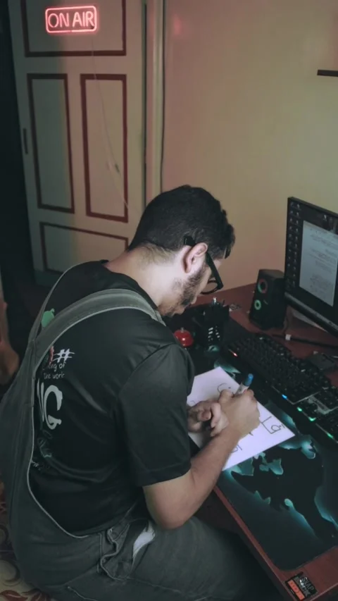 Late-Night Study at Home Desk – Student Writing Beside Computer Video stock 318848092
