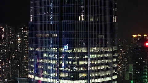 Late-Night Teamwork Inside Glass-Walled Hong Kong Office, Illuminated Workspace Stock-Footage 313716802