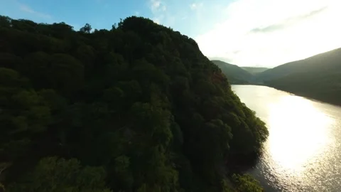 Late Sun FPV Flight Along Forested Glendalough Hillside and Lake 스톡 동영상 344912187
