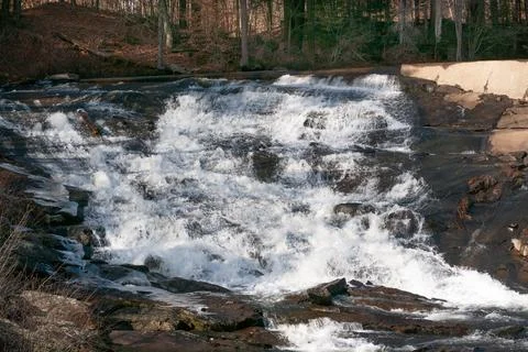 Late winter cascade from dam Stock Photos