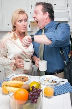 Late for Work Stressed Couple Checking Time in Kitchen. Stock Photos