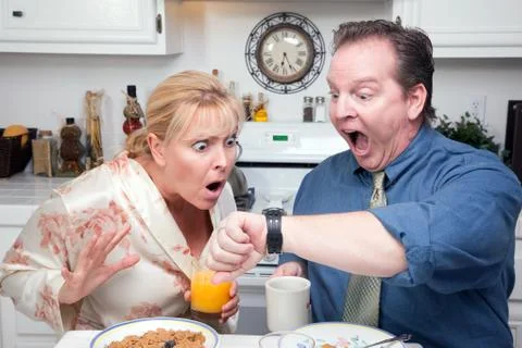 Late for Work Stressed Couple Checking Time in Kitchen. Stock Photos