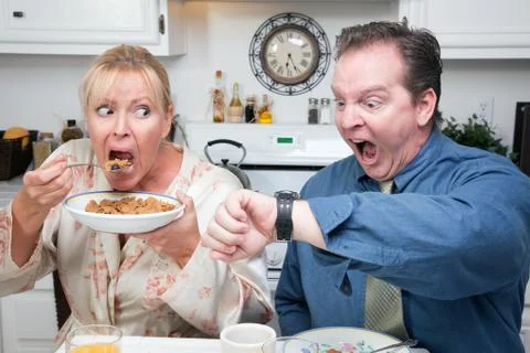 Late for Work Stressed Couple Checking Time in Kitchen. Stock Photos
