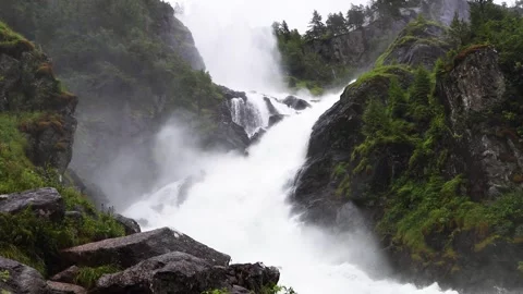Latefossen Waterfall on cloudy, rainy day, surrounded by pine forests in Norway Stock Footage 252693799