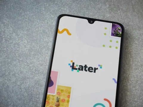 Later app launch screen with logo on the display of a black mobile smartphone Stock Photos