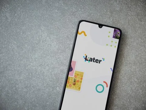 Later app launch screen with logo on the display of a black mobile smartphone Stock Photos