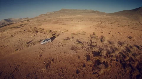 Lateral aerial view of a 4 by 4 car through the desert. Spain. 4k Stock Footage 44788229