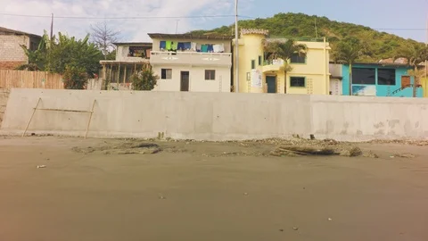 Lateral Dolly Of A Concrete Wall Dividing A Town Stock Footage 93166752