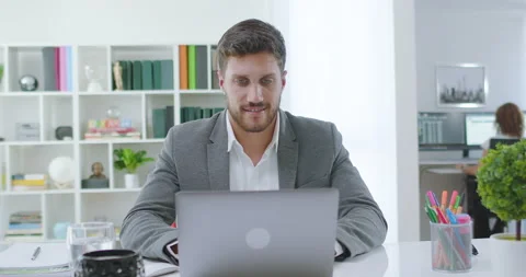 Lateral Dolly of Young Millennial Professional Using Computer at Office. Stock Footage 164050650