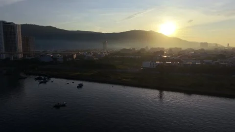 Lateral drone flight along Han River at sunrise in Da Nang, Vietnam Stockbeeldmateriaal 340874521