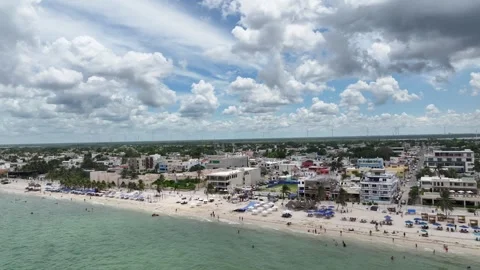 A lateral drone flight over Puerto Progreso, showing the beachfront city with Stock Footage 321449715