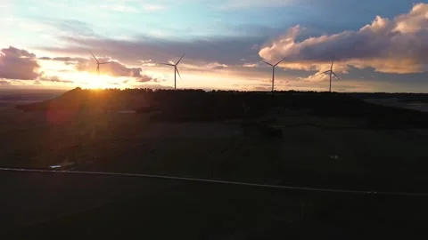 Lateral Drone Movement Along Wind Turbines on Hill at Sunset Silhouette Stock Footage 325796976