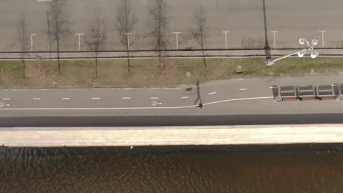 Lateral drone pass above riverside path Stockbeeldmateriaal 324676554