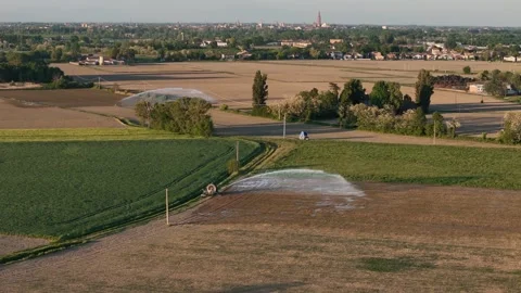 Lateral drone slide above irrigated spring farmland near Castelvetro Piacentino Stock Footage 336625850