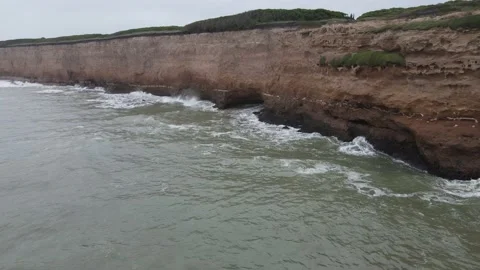 Lateral flight of big cliff front to ocean in Argentina Stock Footage 152668317