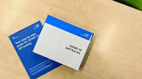 Lateral flow test box and leaflet on a classroom table in a school Stock Photos