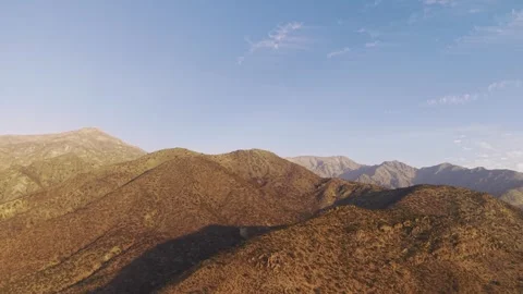 Lateral tracking aerial shot moving across the arid foothills of the Andes Stock Footage 333284128